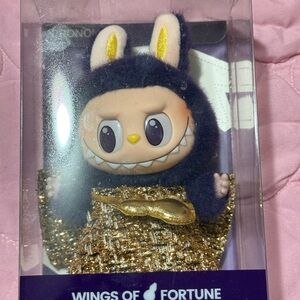 The monsters Labubu Wings of Fortune Plush Doll with Gold and Purple Outfit
